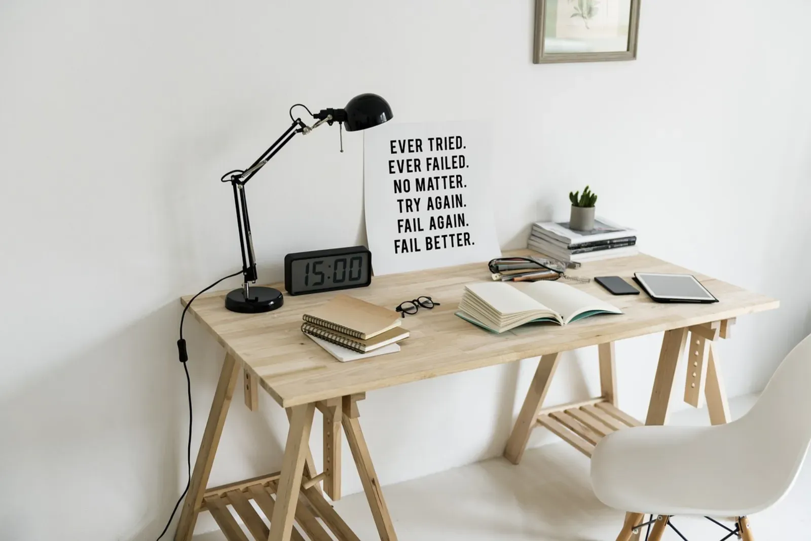 Close-up of a rechargeable Huisio table lamp on a wooden surface beside soft textiles